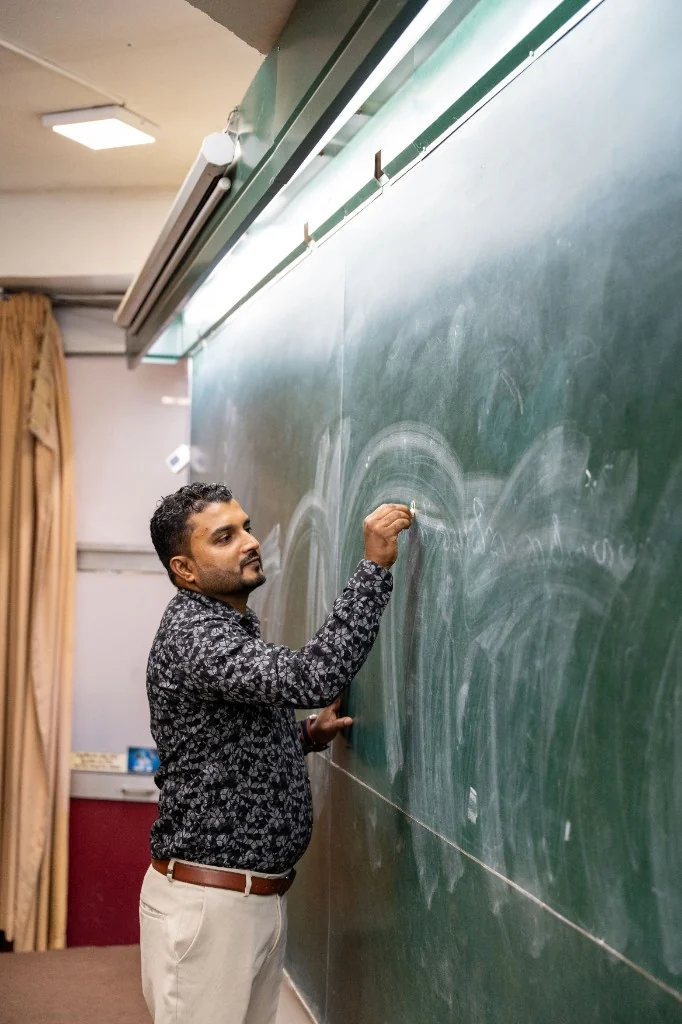 Anurudhdha Rathnayake writing on the chalkboard